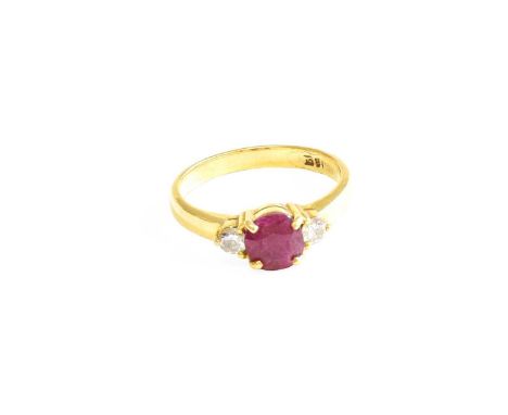 A Ruby and Diamond Three Stone Ring, the round cut ruby flanked by round brilliant cut diamonds, in yellow claw settings, to 