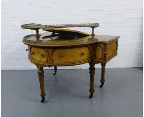 A 19th century satin birch writing desk with a brass galleried shelf over a shaped top with lift up writing slope with black 