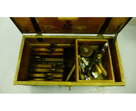A collection of vintage woodworking planes together with a Stanley black metal plane, a vintage tape measure, all contained w