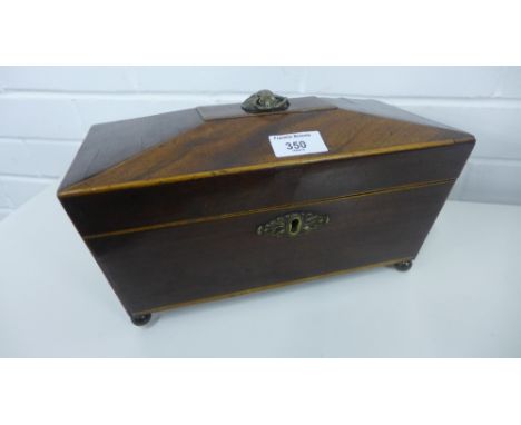 A 19th century mahogany sarcophagus shaped tea caddy with lion mask ring handle to top and escutcheon to front on bun feet, 3