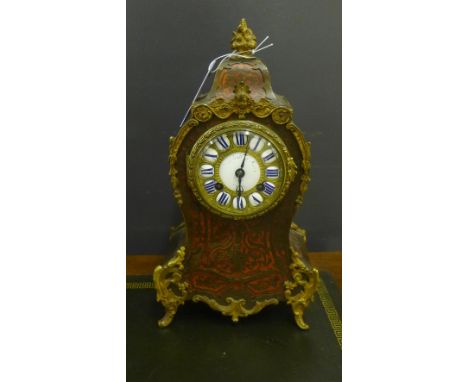 A late 19th century French ormolu mounted Boulle work mantle clock, the domed top with foliate finial above  cherub mounts, t