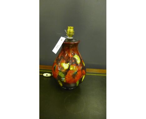 A Moorcroft table lamp, tube line decorated in the orchid design to a red flambe glaze, impressed Moorcroft to the base, 27cm