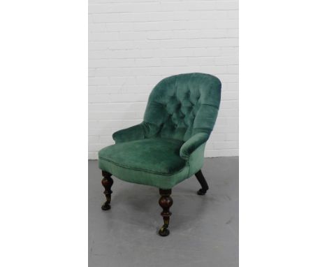An upholstered parlour chair with button back on mahogany supports terminating in brass castors, 79cm x 60cm 