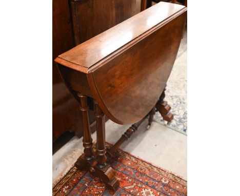 A Victorian mahogany Sutherland table with turned gate-leg action supports 