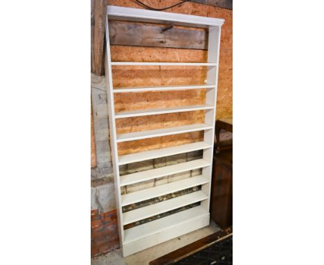 A narrow painted (pine ?) nine shelf open bookcase, 110 cm x 17 cm x 227 cm 