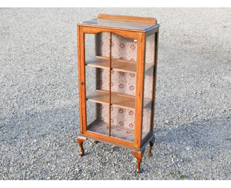 An oak display cabinet with single glazed door, raised on short club legs, 58 cm w x 31 cm x 120 cm h 