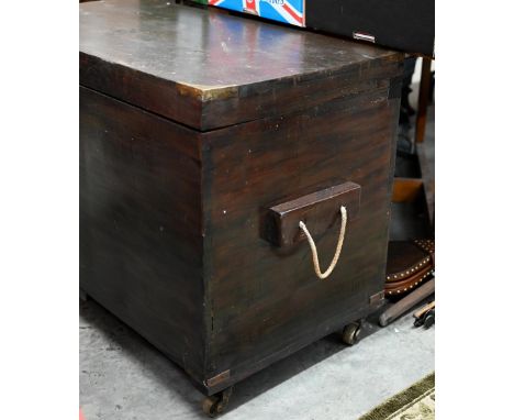 An antique brass bound teak trunk with rope carrying handles, on castors 102 x 54 x 70 cm high 
