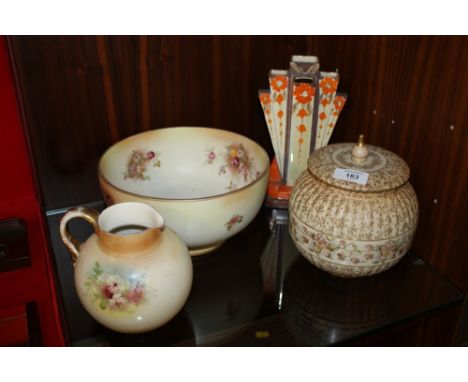 A VINTAGE FLORAL ROYAL DOULTON LIDDED POT, ART DECO VASE, CARLTONWARE BOWL PLUS A ROYAL DEVON JUG (4)