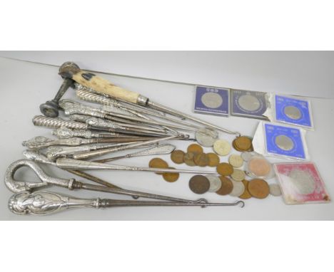 A large collection of silver topped button hooks including one in the form of a swan's head, a William Comyns example, one un