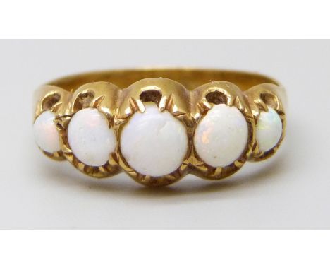 An 18ct gold five stone opal ring, 2.8g, N/O, (chip to central opal and crease to inner shank)