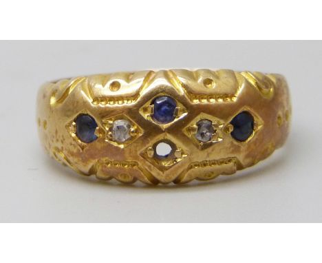 An 18ct gold ring set with blue stones and diamonds, lacking one stone, 2.9g, K
