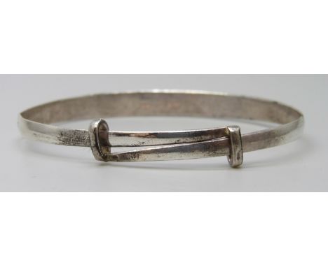 A white metal dragon design bangle with Oriental marks, 13g, a/f