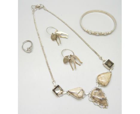 A collection of silver jewellery to include a bangle, ring, and cat earrings, 20g, together with a plated stone set necklace