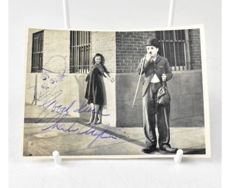 CHARLIE CHAPLIN; a cut photograph from a magazine inscribed 'Good luck', with doodle and signature of the silent movie megast