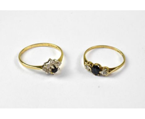 Two 9ct yellow gold dress rings, each set with small sapphires, one ring with central sapphire with white stone to either sid