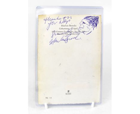 MARLON BRANDO; three photographs of the acting legend, all bearing signatures, one to both front and back (3).We have not aut