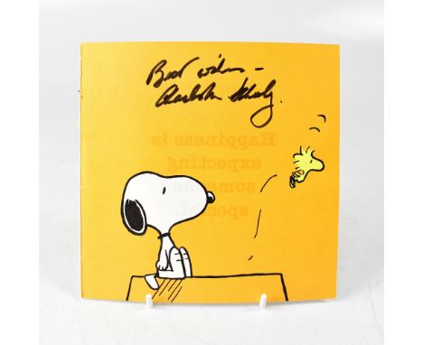 CHARLES SCHULZ; a torn page from a Snoopy book or magazine, bearing the artist's signature.We have not authenticated this sig