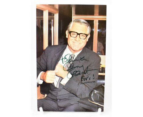 CARY GRANT; a photographic postcard of the star bearing his signature and indistinctly dated. We have not authenticated thIs 