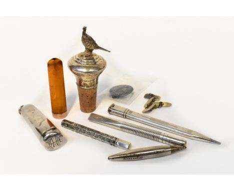 A hallmarked silver bottle stopper with pheasant finial, an amber cheroot holder with rose gold collar, in a hallmarked silve