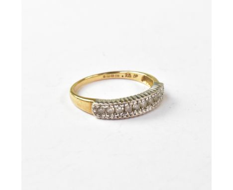A 9ct gold and diamond half eternity ring, with a line of ten small diamonds approx .25ct total, in a white gold mount with t