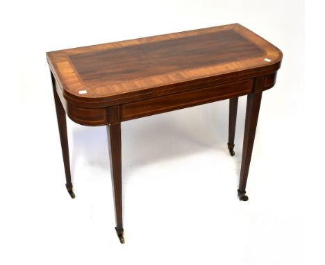 An Edwardian cross banded mahogany and kingwood fold-over gateleg card table with simple frieze, raised on square tapering su