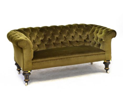 A late 19th century Chesterfield-style two-seater button pressed settee, raised on ebonised and gilt-heightened legs. CONDITI