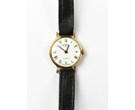 ROTARY; a ladies' 9ct gold wristwatch, the white enamelled dial set with Roman numerals, on a black leather strap. CONDITION 