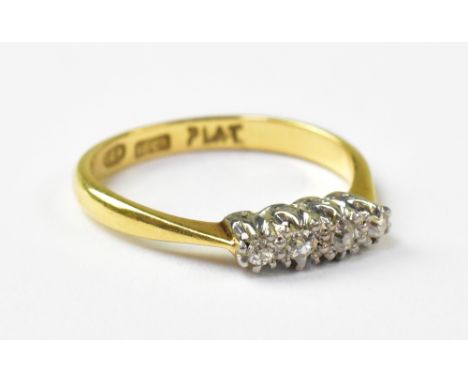 An 18ct diamond engagement ring, the platinum head set with four tiny diamond chips, on an 18ct yellow gold shank, size K, ap