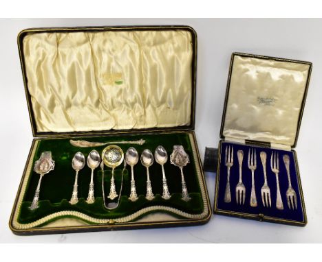 An Edwardian cased afternoon tea set comprising five teaspoons, two preserve spoons, tea strainer ladle, sugar nips and butte