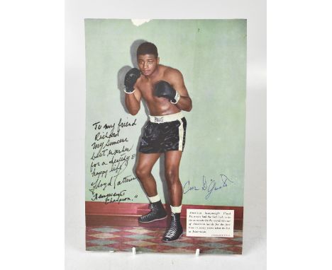 BOXING INTEREST; a page torn from a magazine bearing the signatures of Floyd Patterson and Cas D'Maggio.We have not authentic