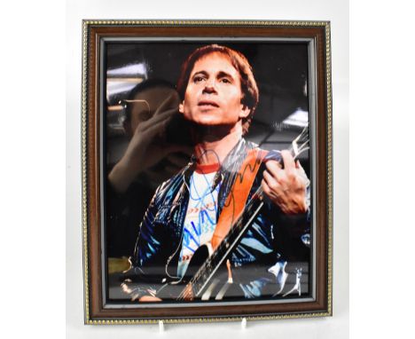 ROCK & POP; a group of nine autographed stock photographs of music stars to include Paul Simon, Robbie Williams, Tom Petty, M