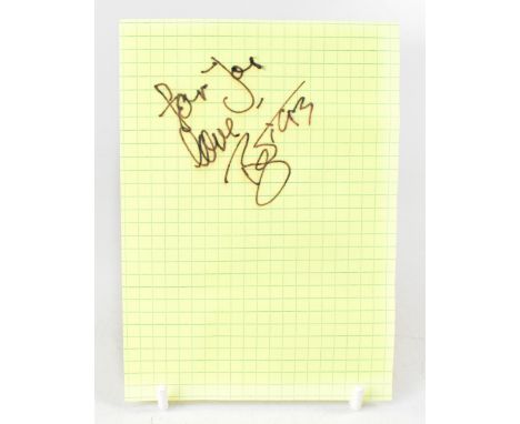 DAVID BOWIE; a piece of graph paper inscribed 'For You Love', bearing the star's signature and dated '93, 15 x 10.5cm.We have