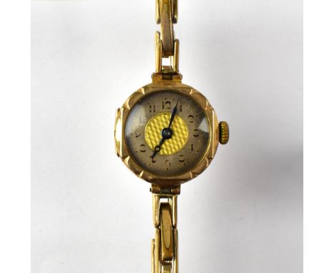 A ladies' vintage 9ct gold wristwatch, the silvered dial set with Arabic numerals and engine turned gold centre, with crown w