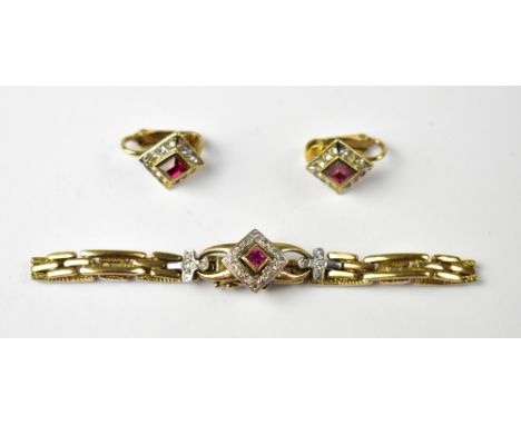 A yellow metal bracelet and matching clip earrings, the chain link bracelet centrally set with a square cut red stone within 