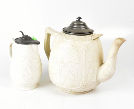 A large Victorian Staffordshire salt glazed relief moulded teapot with pewter lid, height 28cm, and a similar hot water jug, 