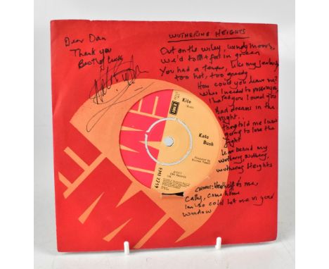 KATE BUSH; a single, 'Wuthering Heights/Kite', bearing the star's signature to the sleeve with handwritten lyrics for 'Wuther