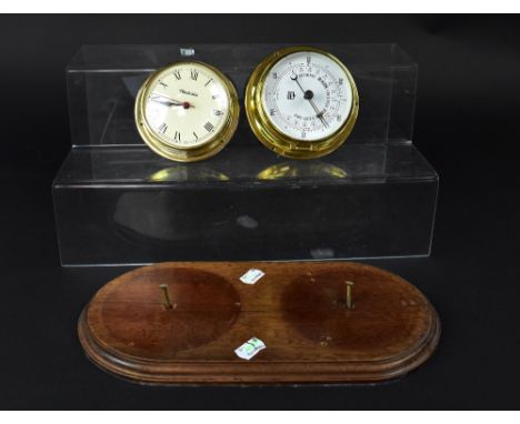 A Nauticalia clock and barometer on a stained oak oval wall-hanging mount and a white marble Classical vase-shaped table lamp