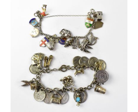 A silver charm bracelet with various charms to include shields, church, galleon, Irish harp, shamrock, loveheart locket, Lond