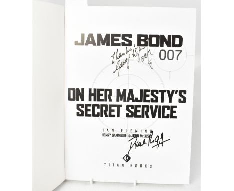 JAMES BOND; 'On Her Majesty's Secret Service', a comic book style book bearing two signatures being George Lazenby and Diana 