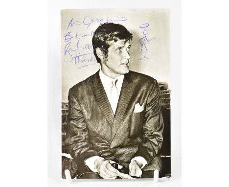 ROGER MOORE; a black and white photograph of the star when portraying 'The Saint' bearing his signature and with doodle of Th