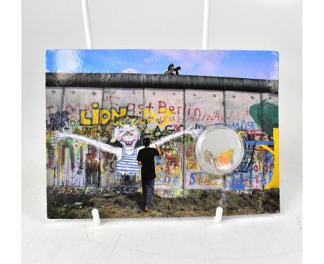 THE BERLIN WALL; two fragments of the Berlin wall encapsulated in a plastic pack, presented in a postcard with three signatur