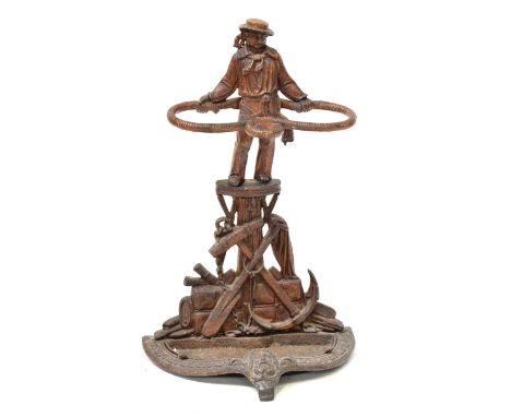 MARITIME INTEREST; a Victorian-style cast iron stick stand modelled as a sailor, with a rope, anchor and paddles, height 70cm