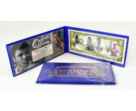 MUHAMMED ALI; a coloured photograph bearing the boxing legend's signature to the reverse, dated 3-4-76, also two commemorativ