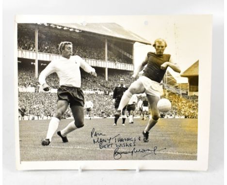 SIR BOBBY MOORE; a black and white photograph with copyright dated 15.8.70 to the reverse, inscribed 'Paul Many thanks and be