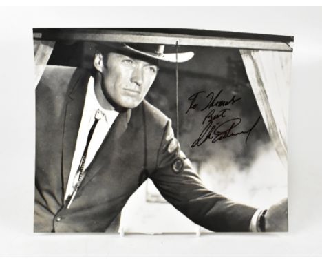 CLINT EASTWOOD; a black and white reproduced photograph of the mega, star bearing his signature, 25.5 x 20.5cm.We have not au