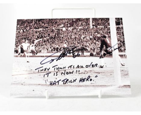SIR GEOFF HURST; a reproduced black and white photograph bearing the football star's signature, inscribed 'They think it's al