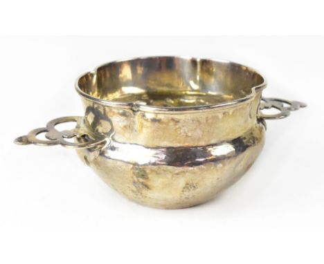 LIBERTY &amp; CO; an Arts &amp; Crafts hallmarked silver twin-handled quaich/bowl, quatrefoil rimmed top, bellowed body with 