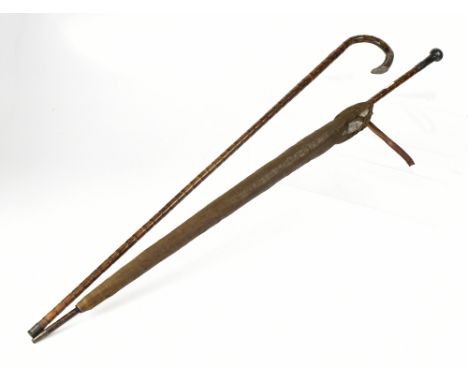 A silver topped bamboo-effect walking stick and a further silver topped bamboo-effect umbrella, marks rubbed (2).