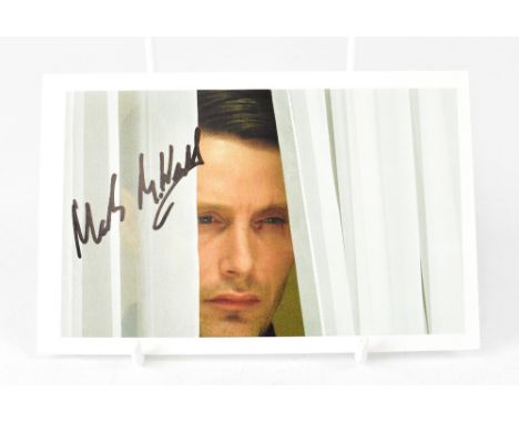 MADS MIKKELSEN; a photographic card depicting the Bond villain from 'Casino Royale' and bearing his signature.We have not aut