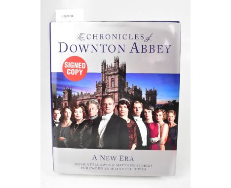 DOWNTON ABBEY; The Chronicles of Downton Abbey', bearing the signatures of numerous stars to the front page and with certific